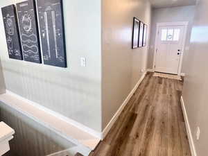 Corridor featuring a textured ceiling and dark wood-style flooring