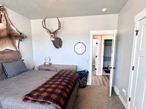 Bedroom with carpet and a textured ceiling
