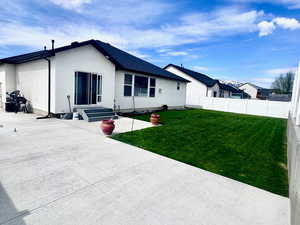 Back of house featuring a patio area, a fenced backyard, and entry steps