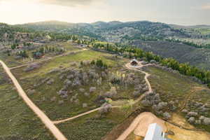 Aerial overview of property's location with a mountain backdrop and rural landscape