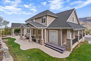 Wraparound covered front and back decks, a private backyard with a natural gas fireplace and waterfall feature, RV parking with electrical hookup, and a 4-car garage, all set on .65 acres with valley and mountain views.