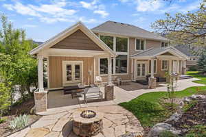 Private backyard featuring a natural gas fireplace and waterfall feature, with a covered patio and outdoor space designed for relaxing and entertaining.