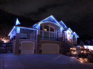Holiday exterior lighting highlights the home’s design, creating a striking presence with valley and mountain views.