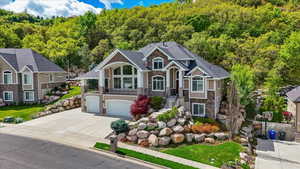 Custom-built Davis County home featuring valley and mountain views, located in a quiet South Weber neighborhood, close to hiking and biking trails, approximately 20 minutes from Snowbasin Ski Resort, and near multiple lakes.