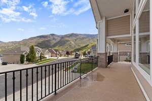 Wraparound covered balcony with valley and mountain views, offering a private outdoor space for relaxing and entertaining.