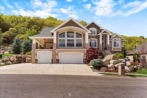 Heated driveway and a 4-car garage with insulated doors, epoxy flooring, and a full-length floor drain, all part of this custom-built Davis County home.