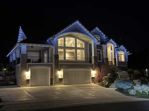 Holiday exterior lighting highlights the home’s design, creating a striking presence with valley and mountain views.