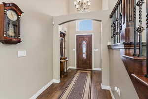 Welcoming entry with engineered hardwood flooring, leading into a layout with abundant natural light and large gathering spaces.