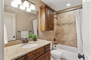 One of four bathrooms featuring granite countertops and a functional layout with updated finishes.