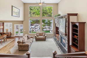 Two great rooms with 20' ceilings, expansive windows, and a gas fireplace create large gathering spaces filled with natural light and views.