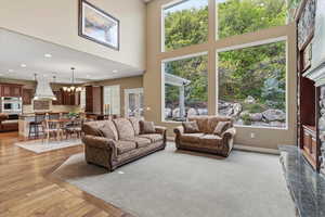 Two great rooms with 20' ceilings and expansive windows maximize natural light, complemented by engineered hardwood flooring and abundant gathering space.