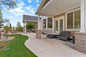 Covered back patio extending along the home, offering a private outdoor space with access to the backyard and areas designed for relaxing and entertaining.