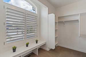 Spacious walk-in closet in the primary suite with built-in shelving and abundant storage.