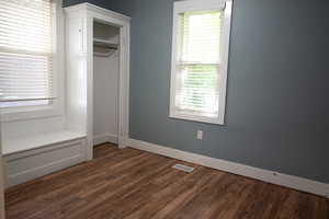 Unfurnished bedroom with dark wood finished floors and a closet