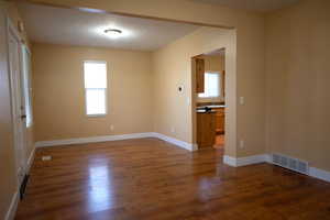 Spare room with dark wood-style floors and a textured ceiling