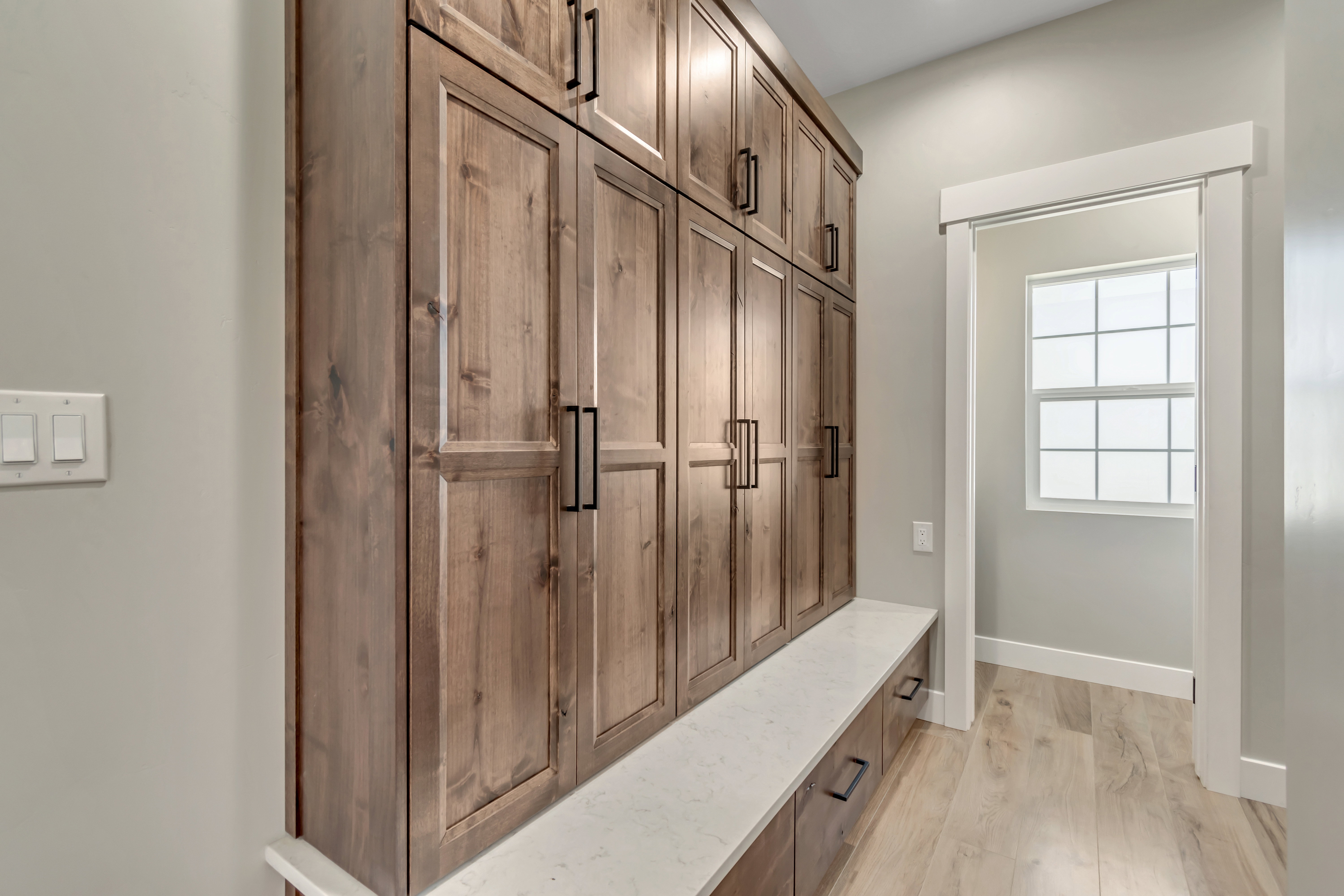 Mudroom with light wood-type flooring and baseboards