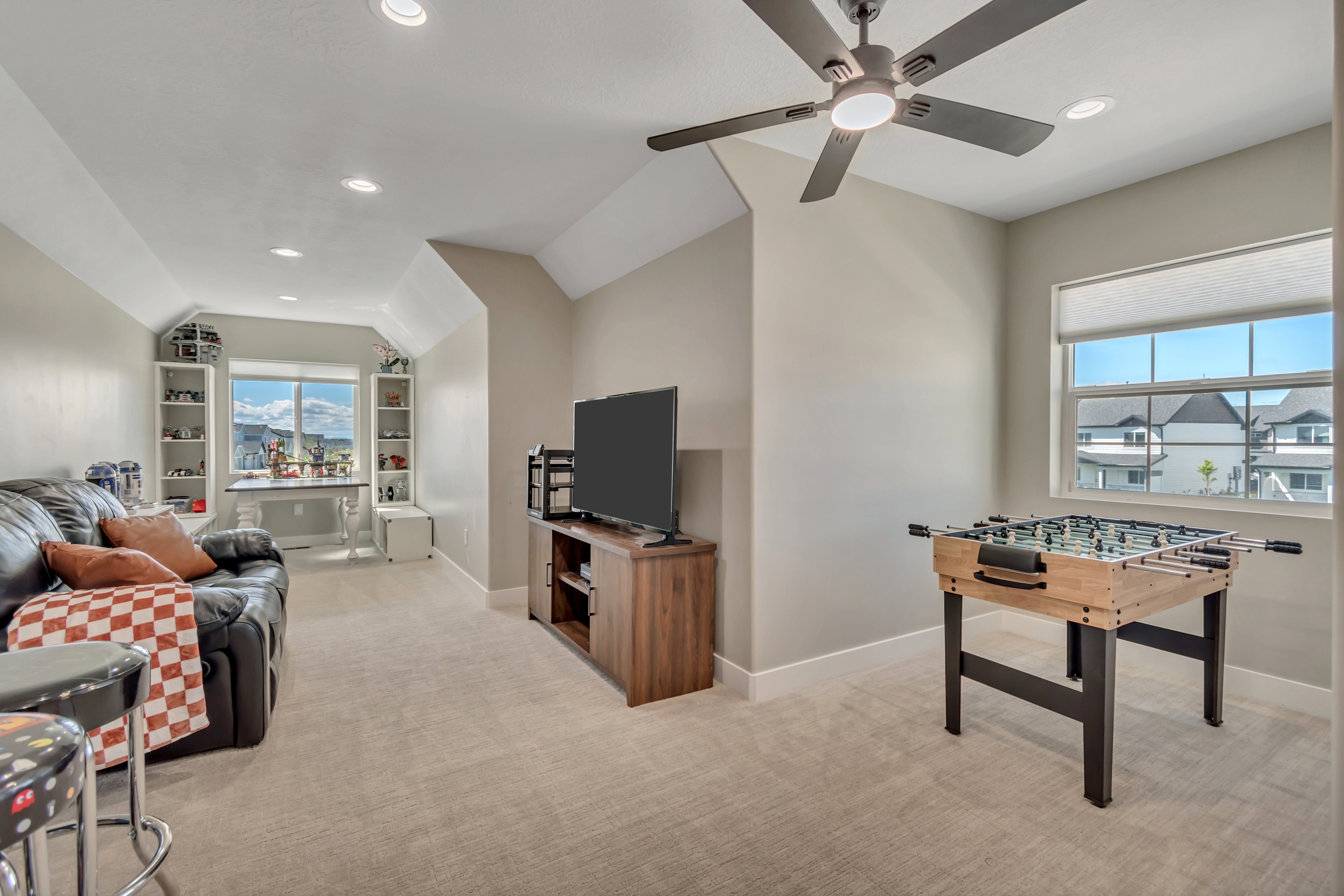 Game room with light carpet, vaulted ceiling, a ceiling fan, healthy amount of natural light, and recessed lighting