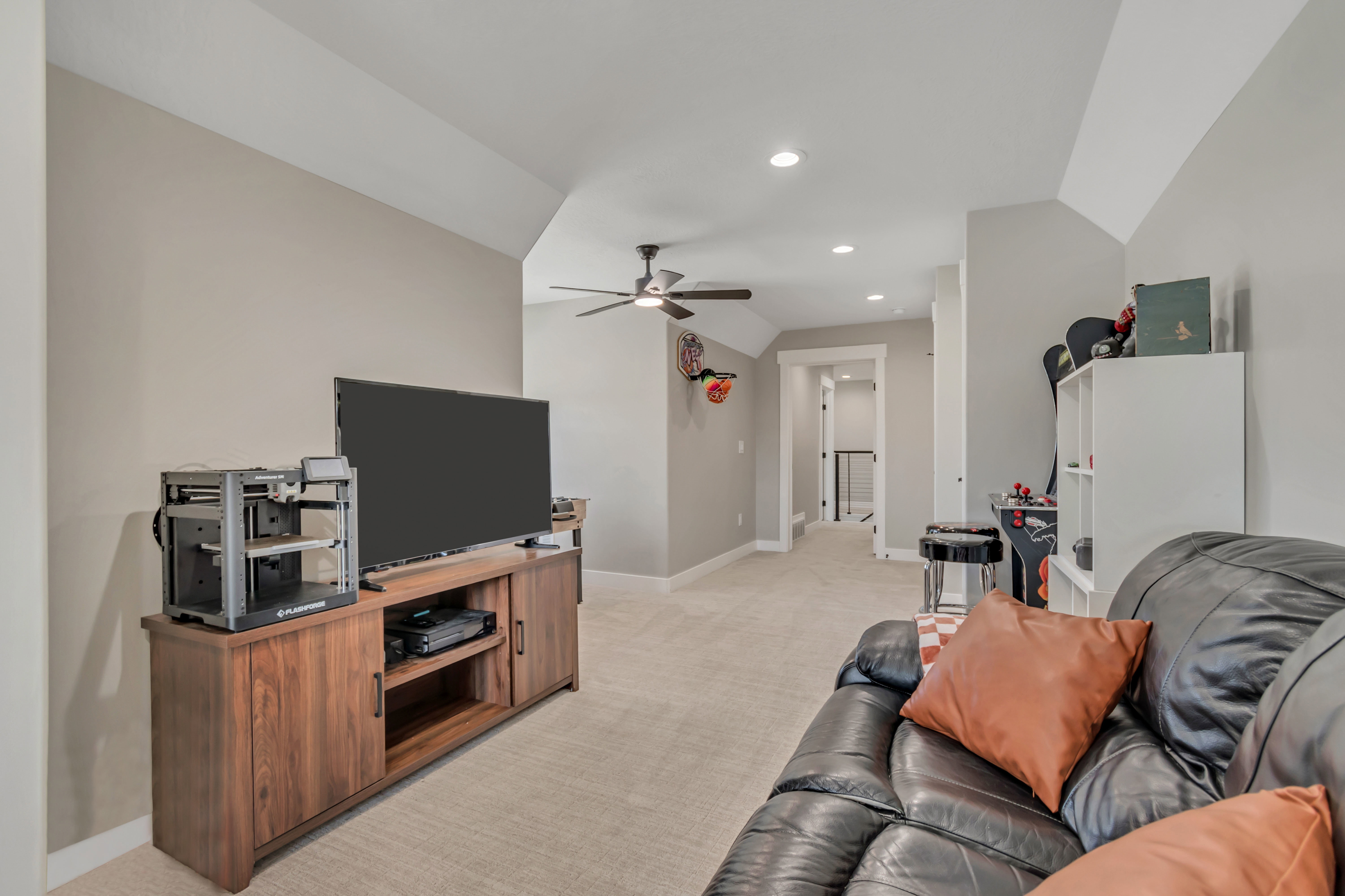 Living area featuring lofted ceiling, light carpet, ceiling fan, and recessed lighting