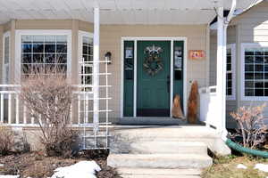Entrance to property featuring a porch