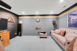 Living area with carpet flooring and recessed lighting