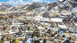 Snowy aerial view with a mountain view and a residential view