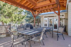 Deck featuring grilling area, outdoor dining area, and french doors