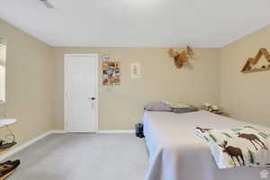 Bedroom featuring carpet floors and baseboards