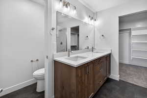 Full bath with a spacious closet and double vanity