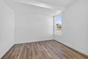 Bonus room featuring light wood-type flooring and baseboards