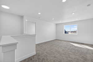 Empty room with carpet flooring, recessed lighting, and a smoke detector