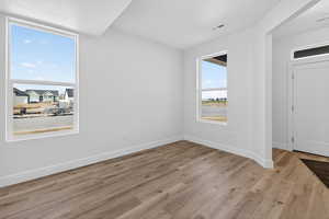 Spare room featuring light wood-style flooring and a textured ceiling