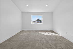 Spare room with baseboards and carpet