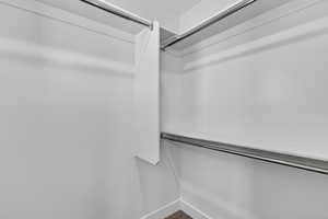 Walk in closet with dark carpet