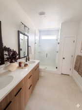 Dual vanity with wood-finish cabinetry and white countertops