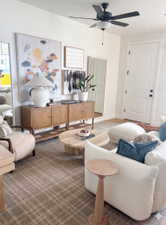 Spacious room featuring a neutral color palette, ceiling fan with integrated lighting, and a paneled interior door with dark hardware