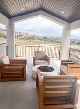 Covered outdoor patio recessed ceiling lighting, a dark-paneled ceiling, and metal railings