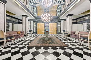 Building lobby featuring crown molding and a decorative wall
