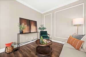 Living area featuring ornamental molding and wood finished floors