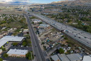 Aerial view of property and surrounding area with a highway and mountains
