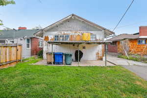 Back of property featuring a patio and a jacuzzi