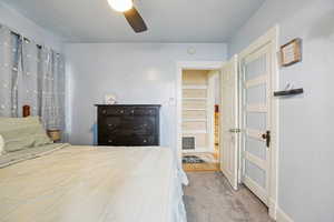 Bedroom featuring light colored carpet and ceiling fan