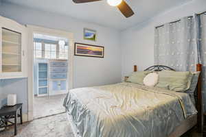 Carpeted bedroom with ceiling fan