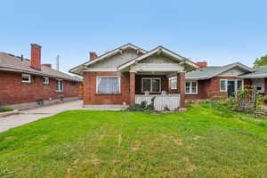 View of front of home featuring a patio and brick siding