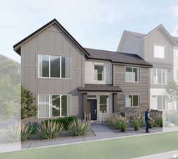 View of front of home featuring board and batten siding and roof with shingles