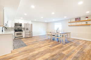 Dining space featuring light wood-style flooring and recessed lighting