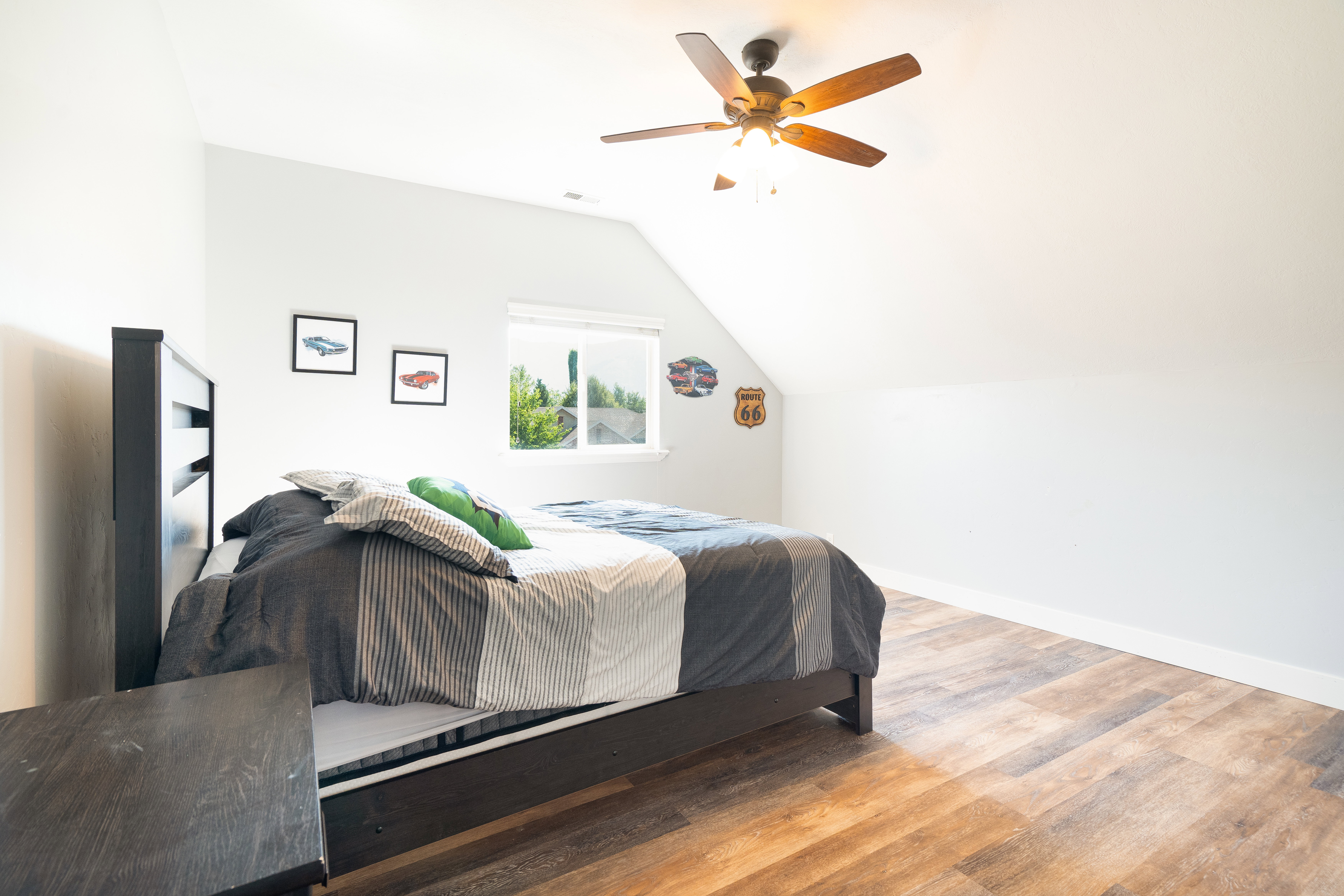 Bedroom featuring light wood-style flooring, ceiling fan, and lofted ceiling