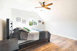 Bedroom featuring light wood-style flooring, ceiling fan, and lofted ceiling