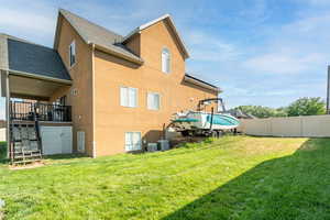 Rear view of property with stucco siding and roof with shingles
