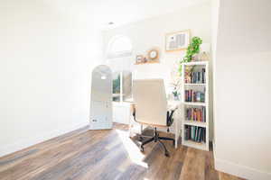 Office space featuring dark wood finished floors and baseboards