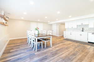 Dining space with light wood-style flooring and recessed lighting